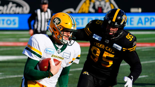 Nov 17, 2019; Hamilton, Ontario, CAN; Hamilton Tiger-Cats defensive lineman Julian Howsare (95) chases Edmonton Eskimos quarterback Trevor Harris (7) during the CFL Eastern Conference Final football game at Tim Hortons Field. Mandatory Credit: John E. Sokolowski-USA TODAY Sports  